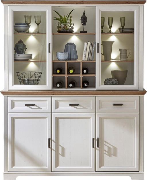 Buffet Geschirrschrank JASMIN in Gesamtansicht mit weißem MDF-Korpus, Artisan-Eiche-Oberböden und beleuchteten Glasvitrinen.