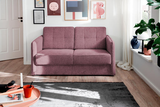 Schlafsofa Funktionssofa MILANO in Rosa, Gesamtansicht im Wohnzimmer mit ausgezogener Liegefläche.