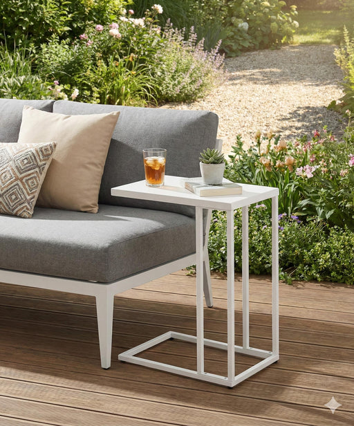 Beistelltisch DOREA mit weißem Metallgestell und weißer Tischplatte neben Gartenlounge.
