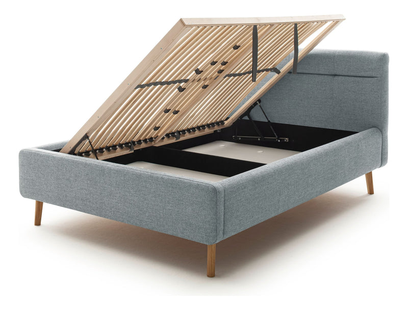 Polsterbett Lotte mit Bettkasten, gestepptem Kopfteil und Holzfüßen in Pastellblau – Ansicht 13