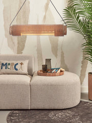 Hängeleuchte Bhutan aus Bambus in Naturfarbe über einem beigen Sofa mit Holztablett und Palmenpflanze.