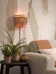 Good&Mojo Wandleuchte Bhutan aus Bambus mit geflochtenem Halbrund-Schirm, über einem Beistelltisch mit Pflanzen montiert.