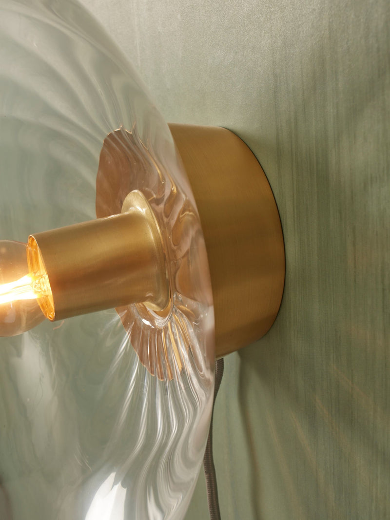 RoMi Wandleuchte Brussels: Detailansicht der goldenen Metallfassung mit welligem Glasschirm und Glühbirne