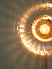Detailansicht der It's about RoMi Wandleuchte Brussels mit goldenem Rand, gerippter Glasschirm und leuchtender Glühbirne.