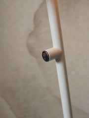 It's about RoMi Stehleuchte Porto in Hellgrau: Detailansicht des weissen Eisengestells mit beigem Schalter mit I/O-Symbol.