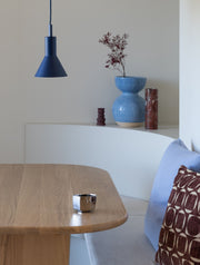 Dunkelblaue Hängeleuchte Stavanger von It's about RoMi aus Metall über einem Holztisch mit Sitzbank.