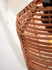 Detailansicht des geflochtenen Rattan-Schirms der Hängeleuchte Tanami mit sichtbarer Lichtquelle und schwarzem Eisengestell.