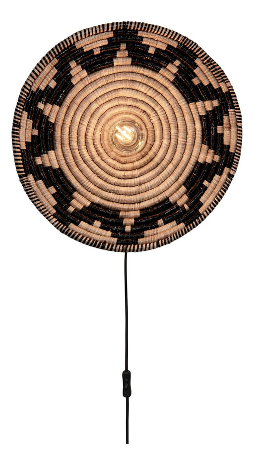 Runde Wandleuchte Andros aus Seegras in Schwarz und Natur mit Spiralmuster, eingeschaltet mit sichtbarer Glühlampe.