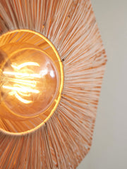 Detailansicht der Deckenleuchte Panama Raffia Octogon S von Good&Mojo: Brauner Raffia-Schirm mit radialen Fasern umrahmt eine Glühlampe.
